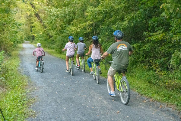 Family riding rental bikes down trail near Harpers Ferry - River & Trail Outfitters