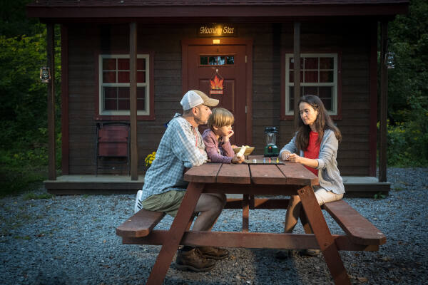 Family plays in front of rental cabin near Harpers Ferry - River & Trail Outfitters