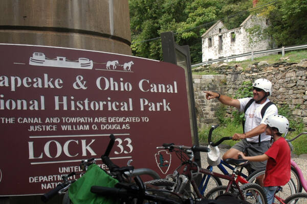 Bikers in front of C&O Canal Lock Cabin rental near - River & Trail Outfitters