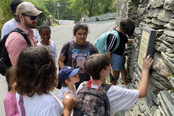 A guide and kids experience a scavenger hunt in Harpers Ferry, WV