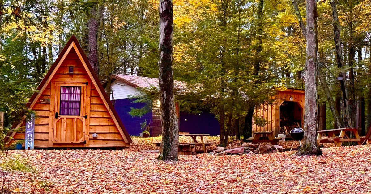 Go camping at Sleepy Hollow Campground in a triangular tiny cabin in the woods.